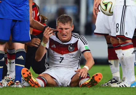 Bastian-Schweinsteiger-getting-hit